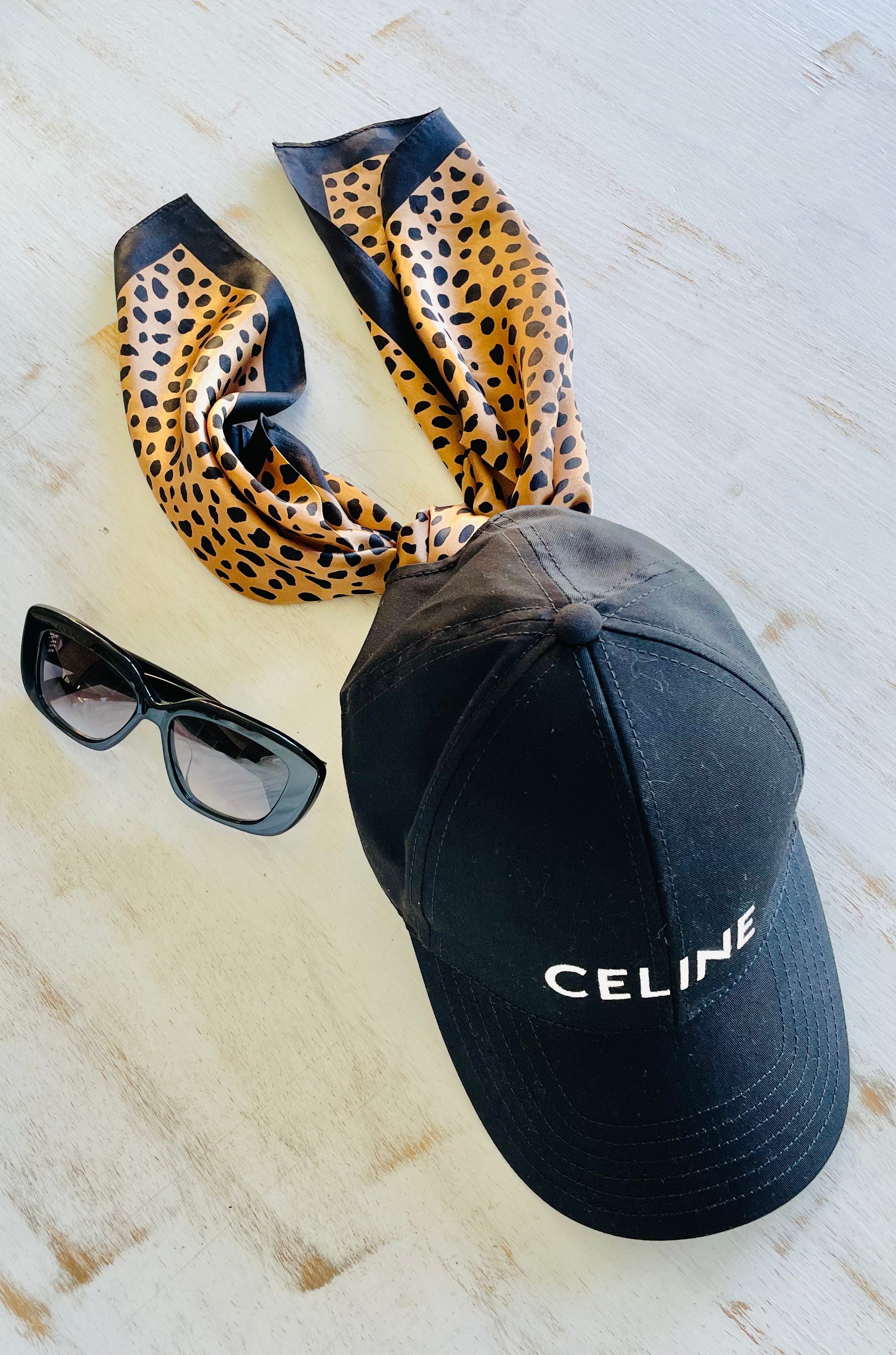 savanna noir silk scarf tied to a baseball hat